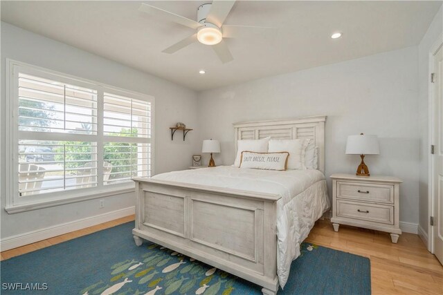 bedroom with ceiling fan and light wood-type flooring