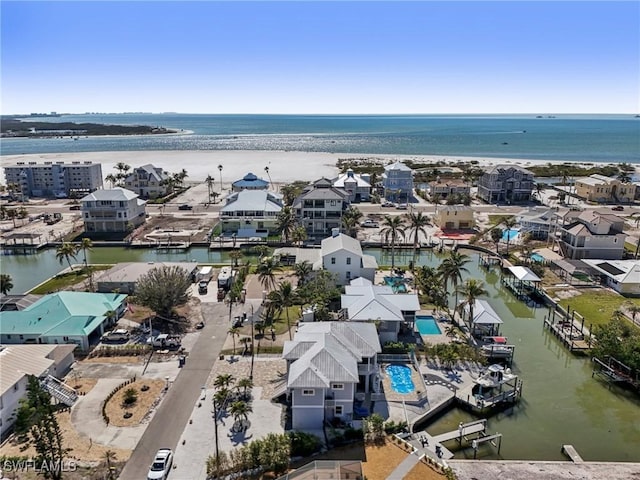 aerial view with a beach view and a water view