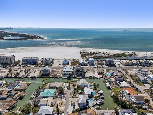 drone / aerial view with a water view and a beach view