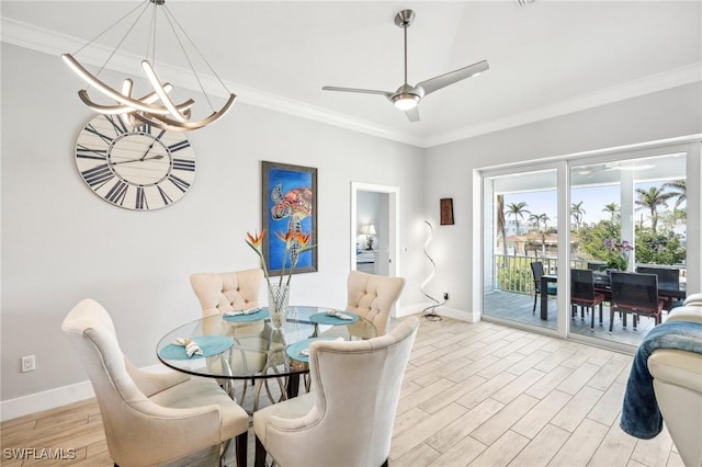 dining space with crown molding, ceiling fan with notable chandelier, and light hardwood / wood-style floors