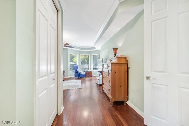 hall featuring ornamental molding and dark hardwood / wood-style flooring