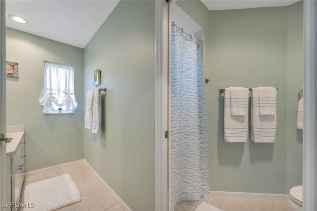 bathroom featuring tile patterned floors, vanity, and toilet