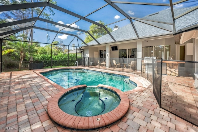 view of swimming pool featuring an in ground hot tub, a patio area, and glass enclosure