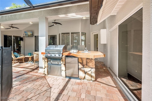 view of patio / terrace with ceiling fan, area for grilling, grilling area, and exterior bar