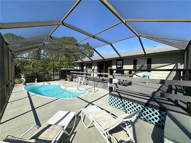 view of swimming pool with a patio area and glass enclosure