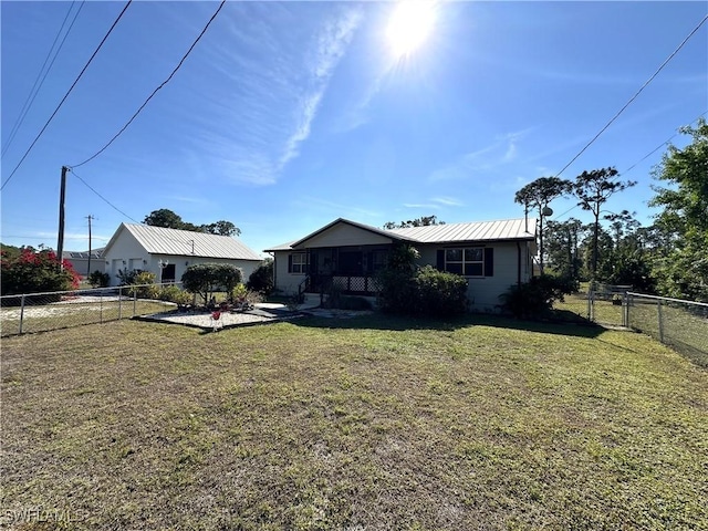 rear view of property featuring a yard