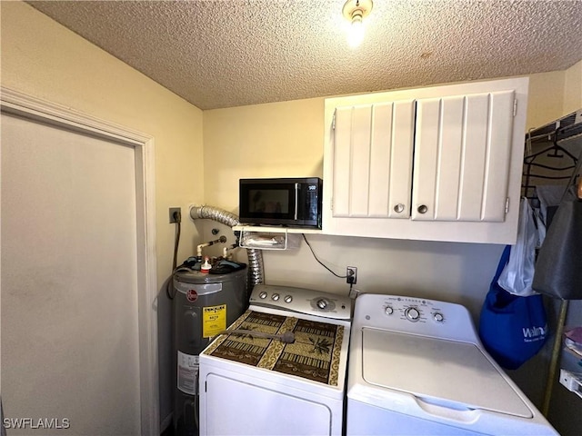 laundry area with separate washer and dryer, cabinets, water heater, and a textured ceiling