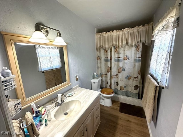 bathroom featuring vanity, hardwood / wood-style flooring, toilet, and a shower with shower curtain