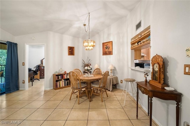 tiled dining room featuring vaulted ceiling and a chandelier