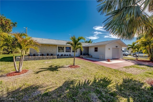 view of front of property featuring a garage, a patio area, and a front yard