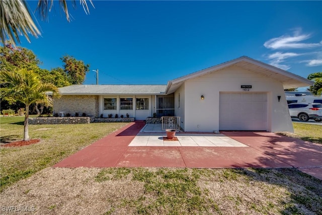 ranch-style house featuring a garage, a front yard, and a patio