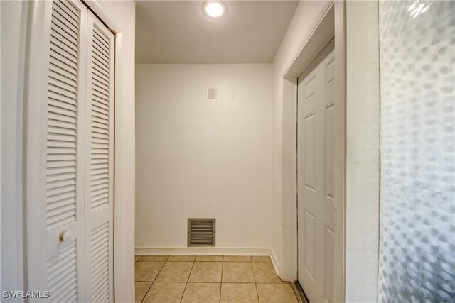 corridor with light tile patterned floors