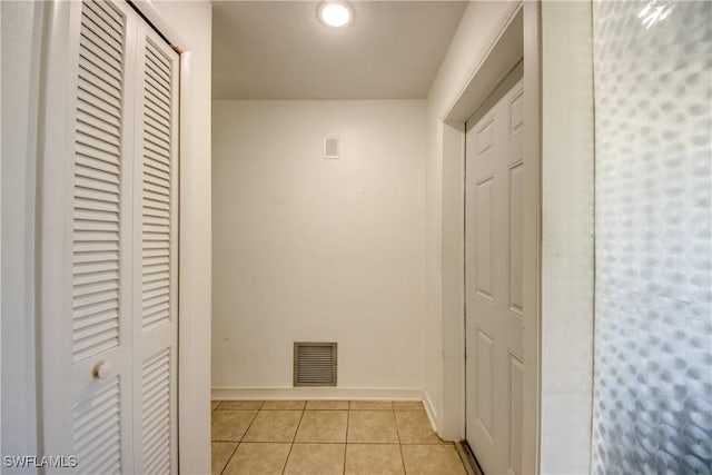 hallway featuring light tile patterned floors