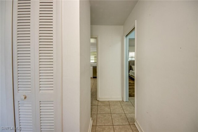 corridor featuring light tile patterned floors