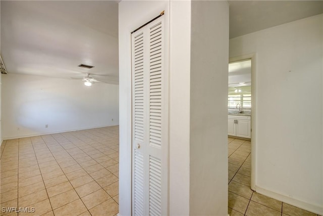 hall featuring light tile patterned floors