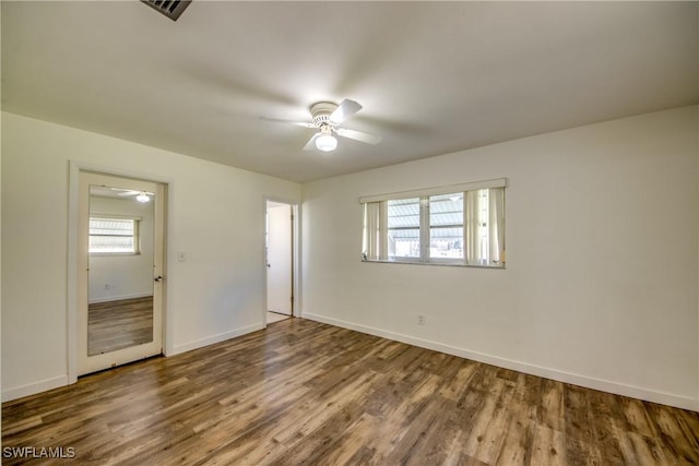 unfurnished bedroom with ceiling fan and wood-type flooring