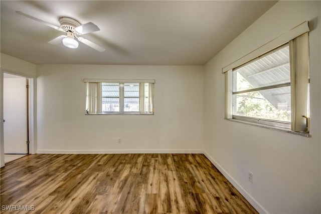 empty room with hardwood / wood-style floors and ceiling fan