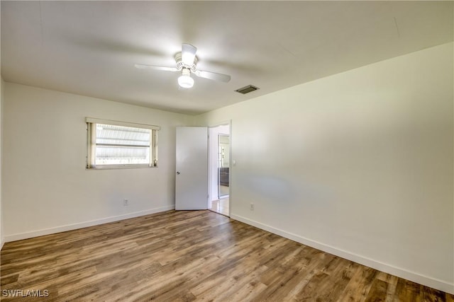 empty room featuring ceiling fan and wood-type flooring