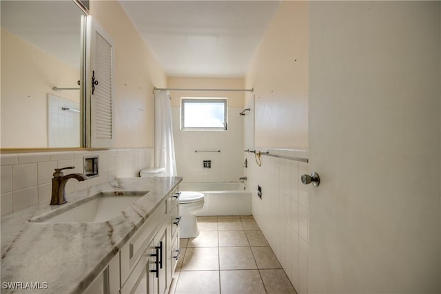 full bathroom featuring tile walls, vanity, shower / tub combo, toilet, and tile patterned floors