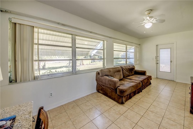 living room featuring light tile patterned floors and ceiling fan