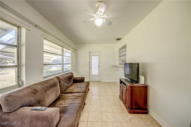 tiled living room with ceiling fan