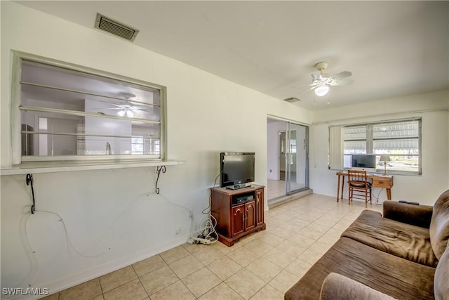 tiled living room with ceiling fan