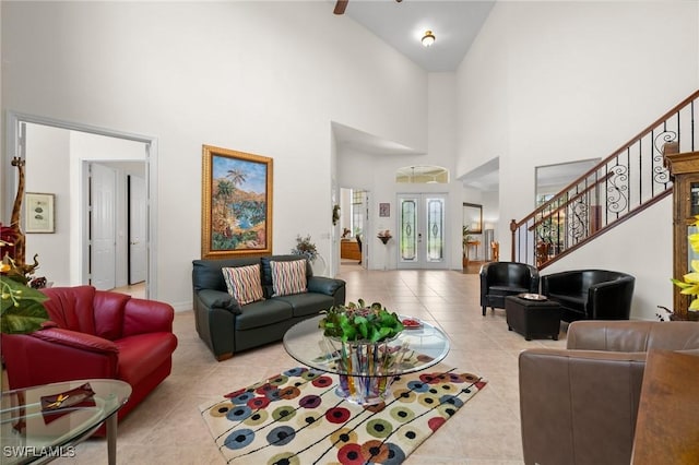 living room featuring a high ceiling, light tile patterned floors, and french doors