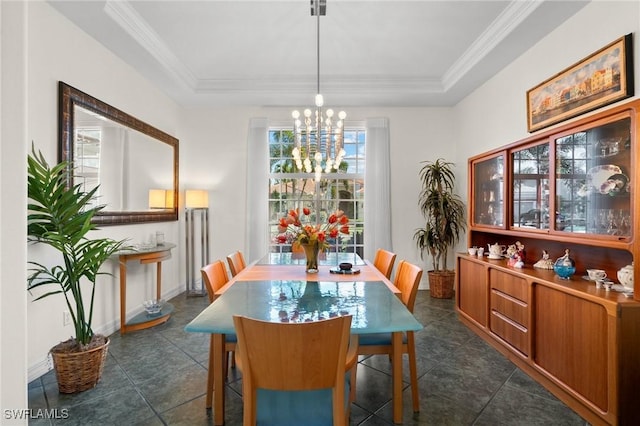 dining area with crown molding, a raised ceiling, and a chandelier