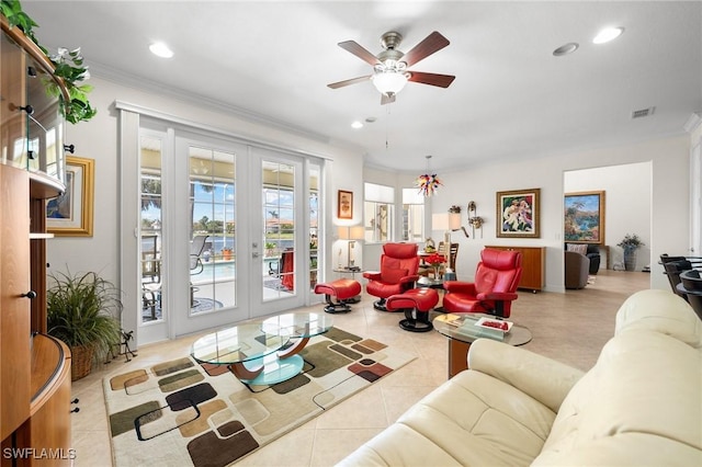 living room featuring light tile patterned floors, crown molding, french doors, and ceiling fan