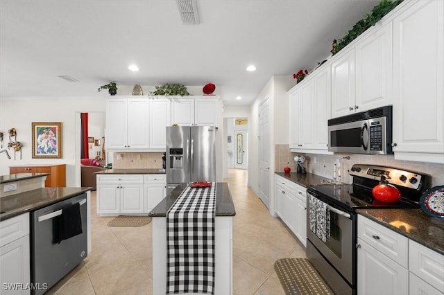 kitchen featuring white cabinetry, light tile patterned floors, a kitchen island, and appliances with stainless steel finishes