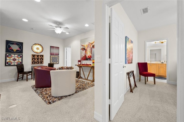 carpeted living room with ceiling fan