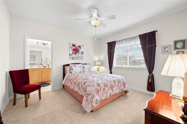 carpeted bedroom featuring ceiling fan and ensuite bathroom