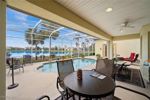 view of pool featuring a lanai, a patio, and a water view