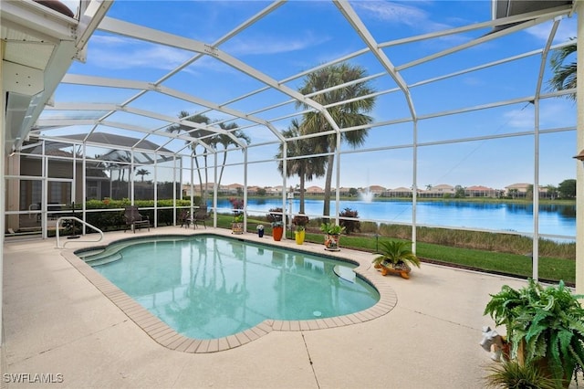 view of pool with a patio, a water view, and glass enclosure