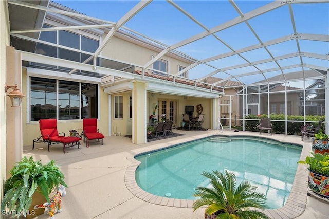 view of swimming pool with a patio and glass enclosure