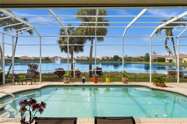 view of swimming pool with a lanai, a patio area, and a water view