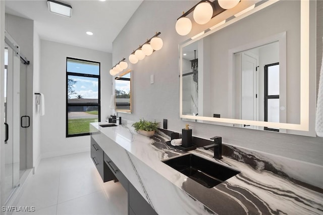 bathroom with vanity, tile patterned flooring, and a shower with door