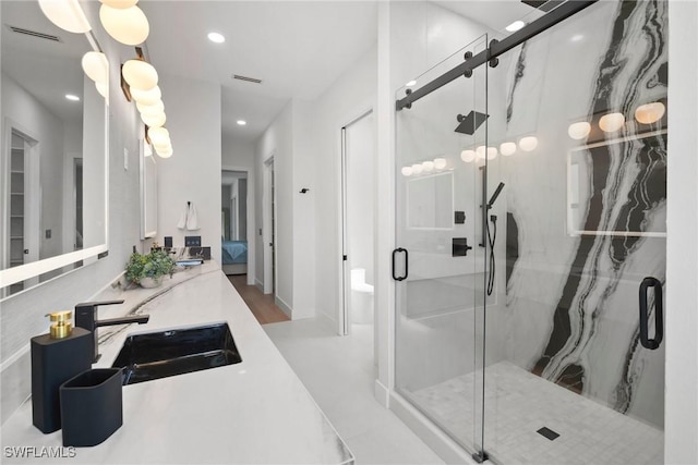 bathroom featuring vanity and a shower with shower door