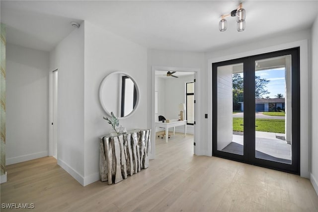 doorway with light hardwood / wood-style flooring and french doors