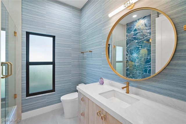 bathroom with vanity, toilet, a shower with shower door, and tile walls