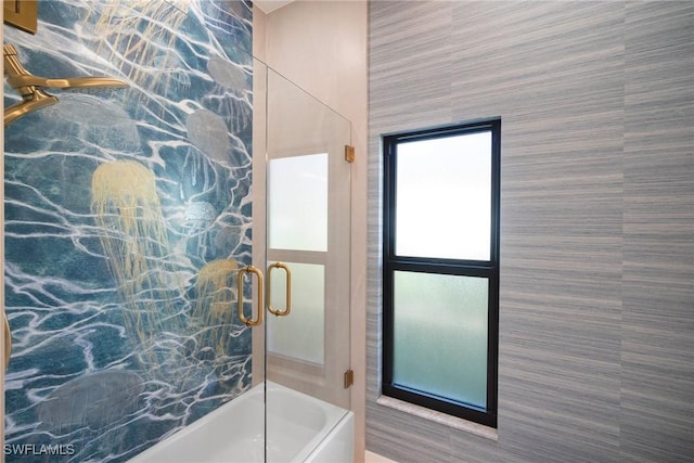 bathroom featuring bath / shower combo with glass door