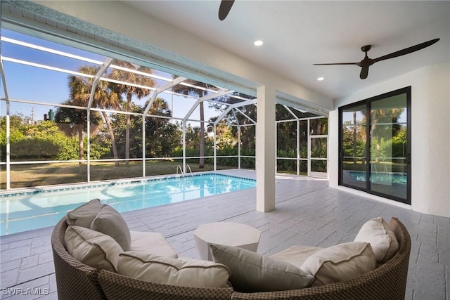 view of swimming pool featuring outdoor lounge area, ceiling fan, a lanai, and a patio area