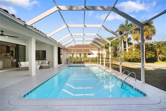 view of swimming pool featuring ceiling fan, a lanai, an outdoor hangout area, and a patio area