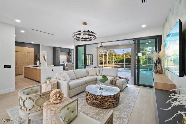 living room featuring sink and light hardwood / wood-style flooring