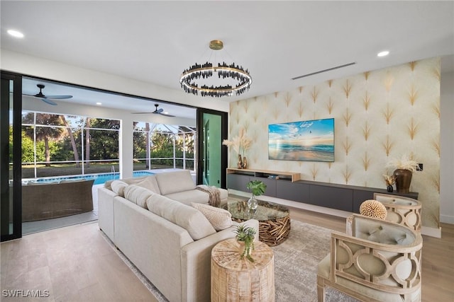 living room featuring light hardwood / wood-style floors and ceiling fan