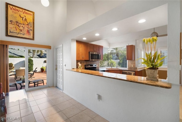 kitchen featuring light tile patterned flooring, stainless steel appliances, sink, and backsplash