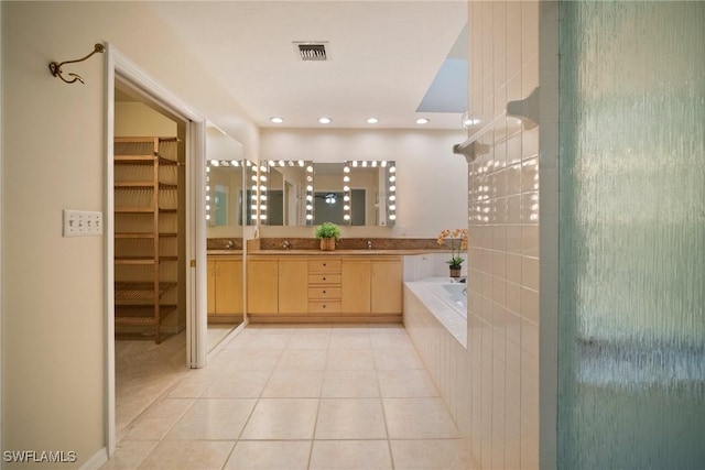 bathroom with tile patterned floors, independent shower and bath, and vanity