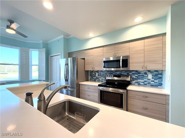 kitchen featuring tasteful backsplash, stainless steel appliances, crown molding, and sink