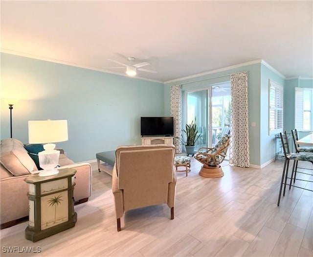 living room with crown molding, ceiling fan, and light hardwood / wood-style flooring