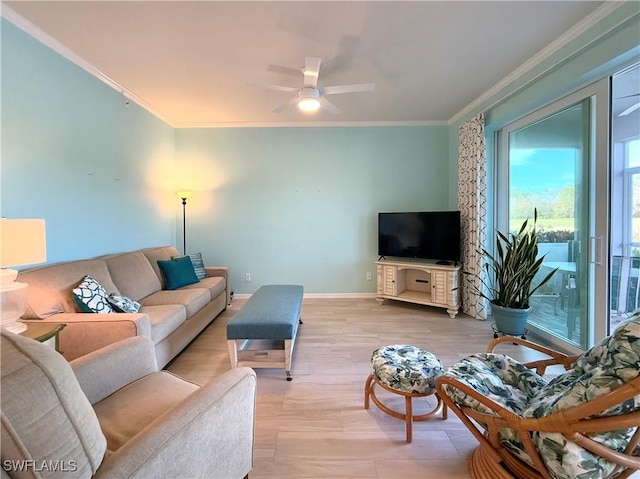 living room with ornamental molding, ceiling fan, and light hardwood / wood-style floors